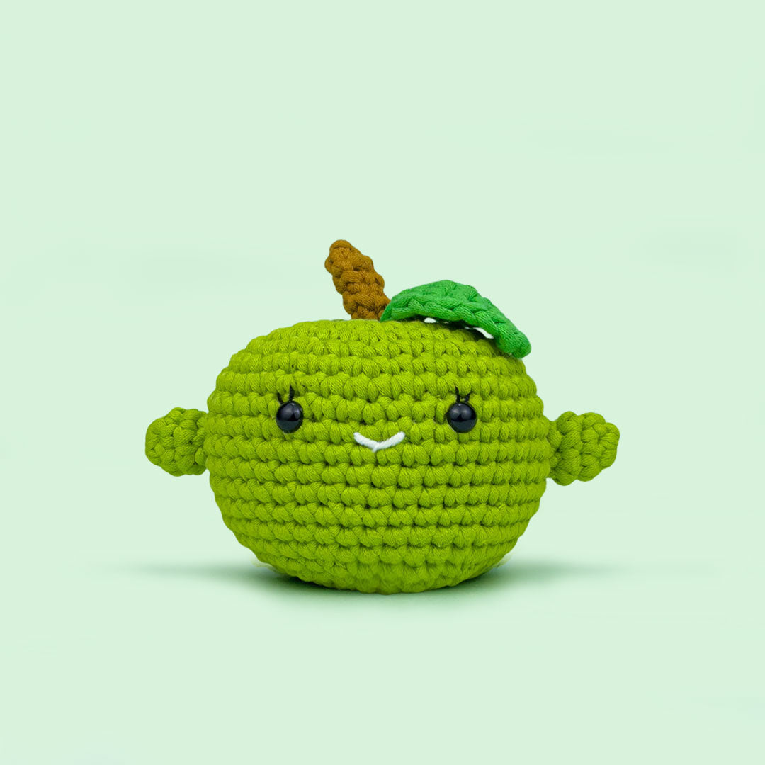 The Cute Crochet handmade apple - dark green crochet apple with a smiling face and leaf detail