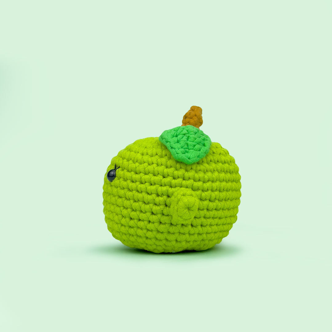 The Cute Crochet handmade apple - dark green crochet apple with a smiling face and leaf detail