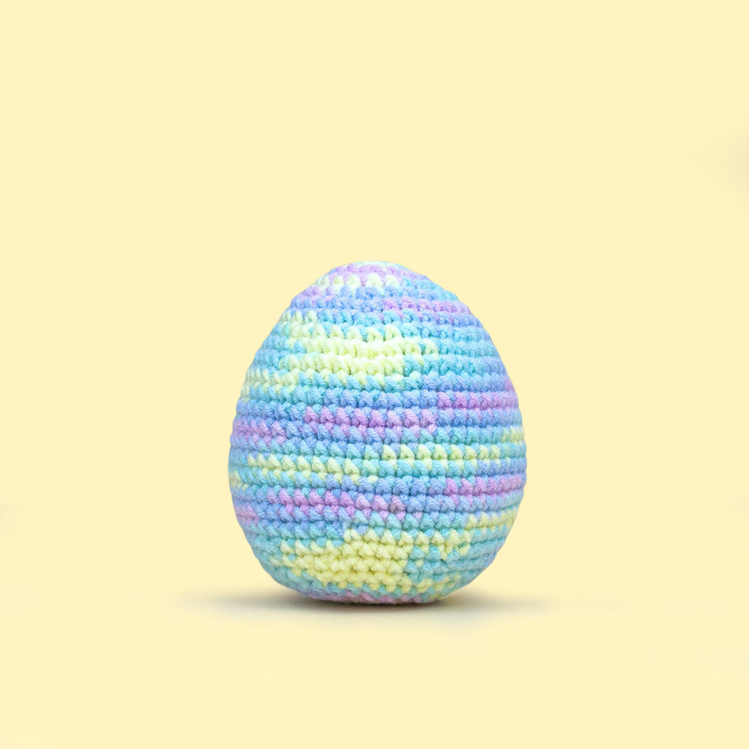 The Cute Crochet handmade Easter egg - light pastel blend with soft lavender, blue, and yellow shades