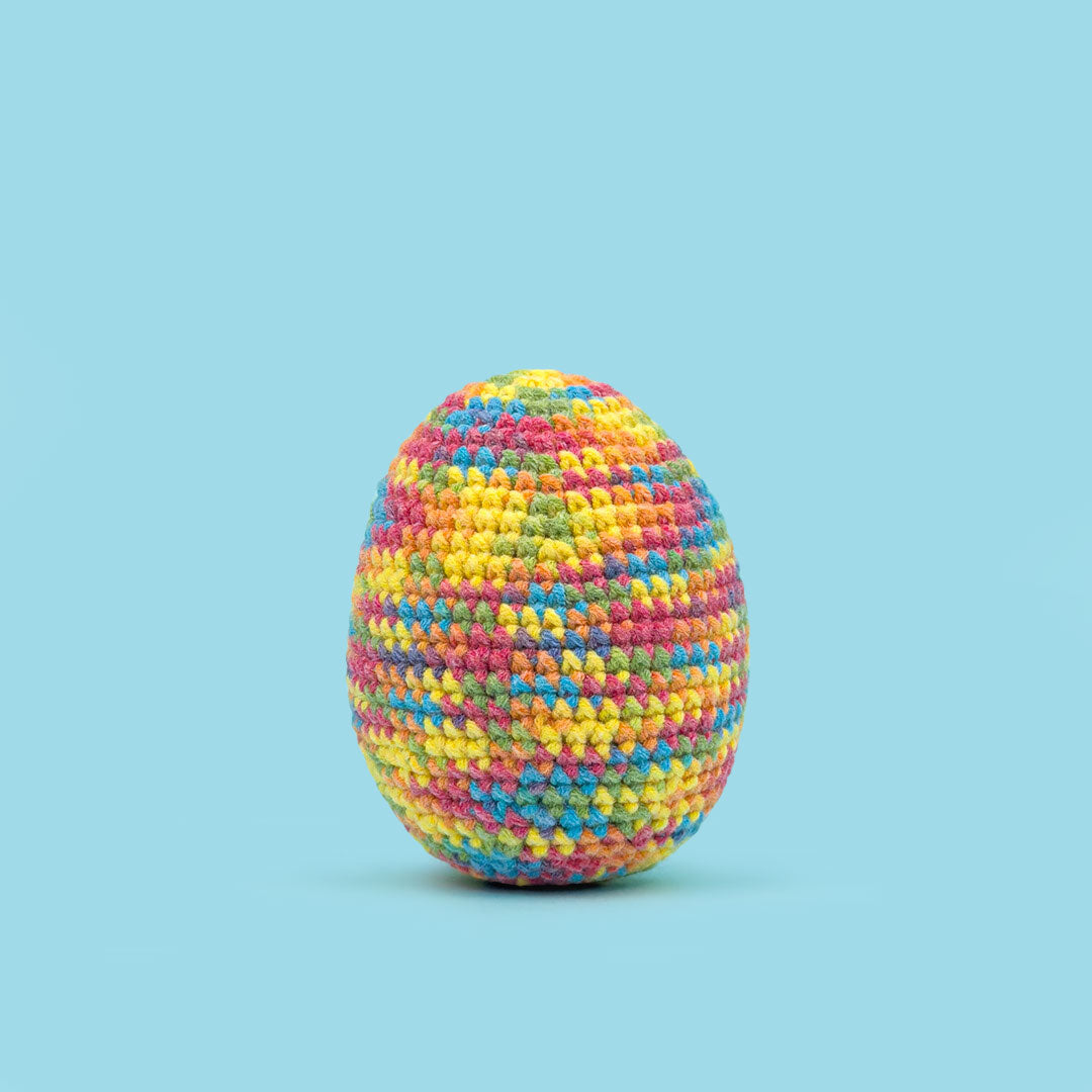The Cute Crochet handmade Easter egg - multicolor yarn with red, yellow, and blue tones