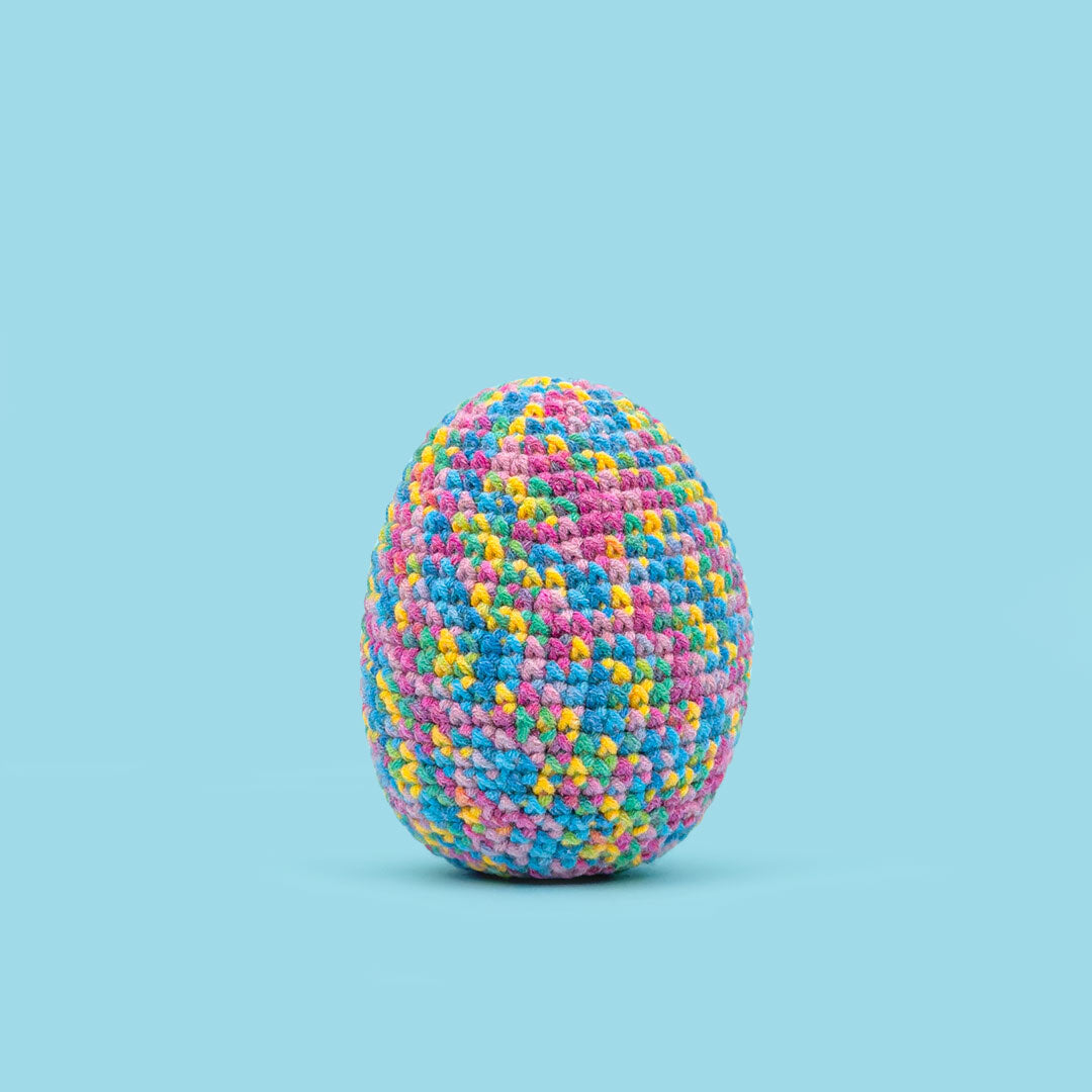 The Cute Crochet handmade Easter egg - vibrant rainbow yarn with a mix of warm and cool tones