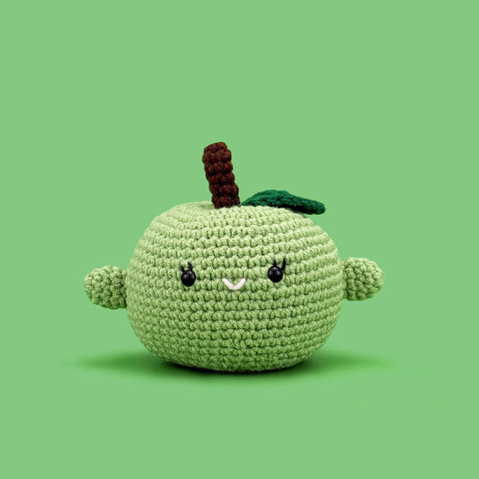 The Cute Crochet handmade apple - light green crochet apple with a cute face and stem